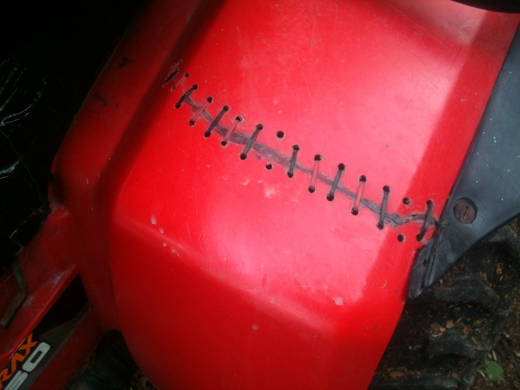 Four wheeler fender repaired with zip-ties and caulk